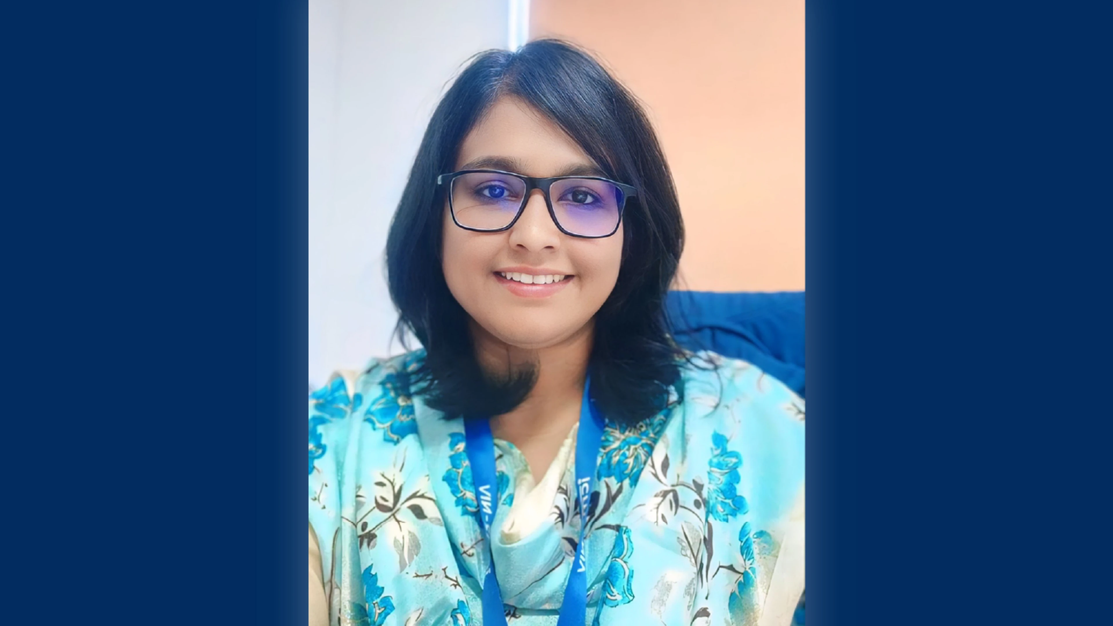 headshot of Rima Sahay on blue background